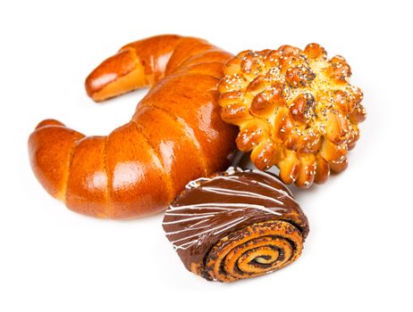 Fresh and tasty buns with with sesame and poppy seeds, bagel with jam and roll with chocolate over white background