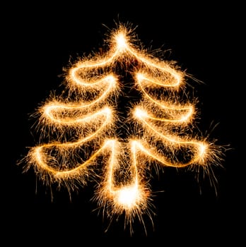 Christmas tree made by sparkler on a black background