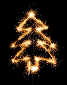 Christmas tree made by sparkler on a black background