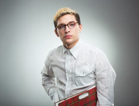 Young serious man looking to the camera wearing glasses