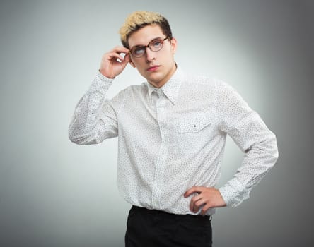 Young serious man looking to the camera wearing glasses