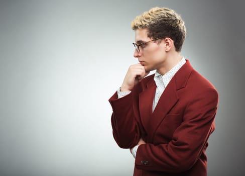 Young man with glasses thinking