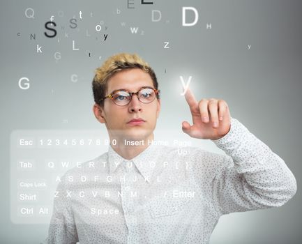 Young businessman pressing application button on computer with touch screen