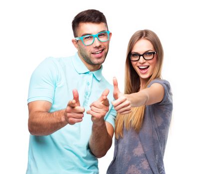 Happy couple smiling holding thumb up gesture, beautiful young man and woman smile looking at camera on white