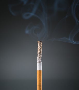 Smoking cigarette on black background