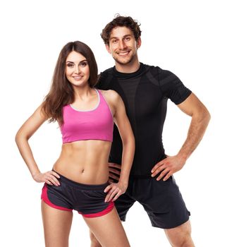 Athletic couple - man and woman after fitness exercise on the white background