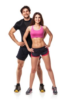 Athletic couple - man and woman after fitness exercise on the white background