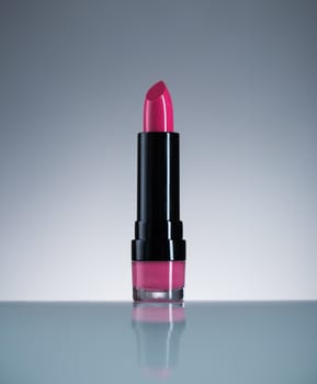 Pink lipstick with reflection, beauty concept