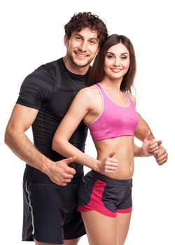 Athletic man and woman after fitness exercise with a finger up on the white background