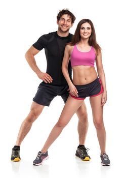 Athletic couple - man and woman after fitness exercise on the white background