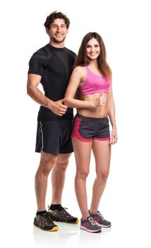 Athletic couple - man and woman with thumb up on the white background