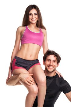 Sports guy holds on shoulder a girl on a white background