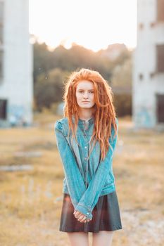 Young stylish girl with dreadlocks outdoors