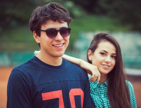 Young beautiful couple on the tennis court