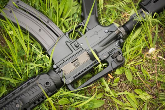 Automatic rifle in the grass closeup