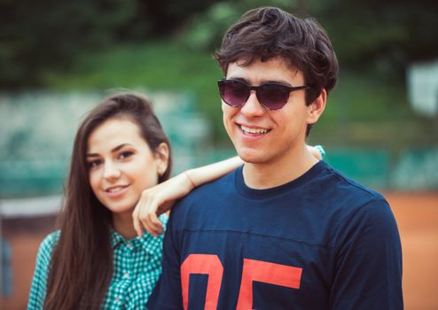 Young beautiful couple on the tennis court