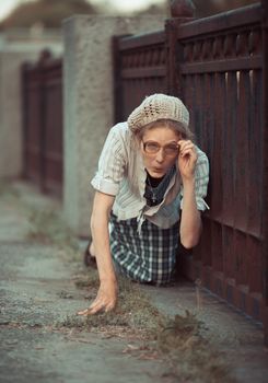 Funny girl with glasses and a vintage dress outdoors