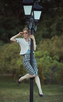 Funny girl with glasses and a vintage dress outdoors