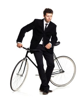 Attractive man in a classic suit with a bicycle on a white background