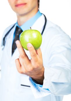 Doctor's hand holding a fresh green apple close-up on white background
