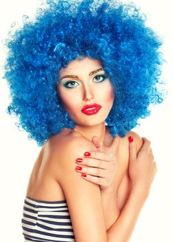 Portrait of a young beautiful girl with bright makeup, red lips in blue wig