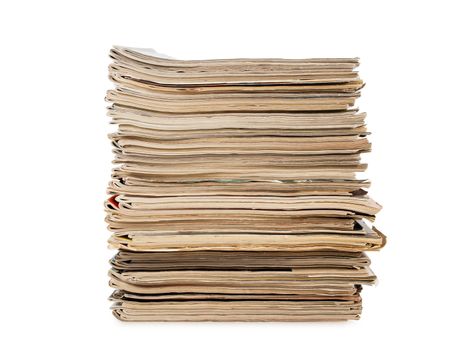 a pile of old yellow magazines isolated on white background, studio shot