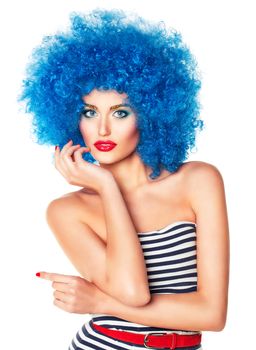 Portrait of a young beautiful girl with bright makeup, red lips in blue wig