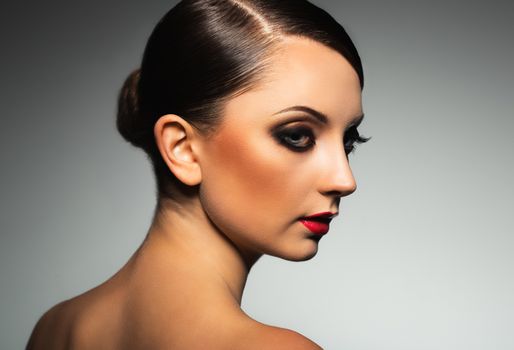 Portrait of a beautiful young woman with a glamorous retro makeup