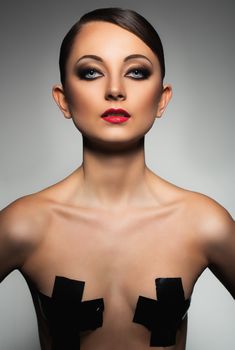 Portrait of a beautiful young woman with a glamorous retro makeup