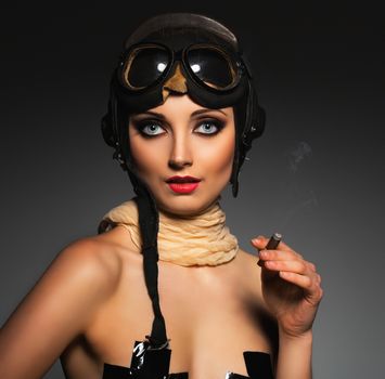 Portrait of a beautiful young woman aviator with a glamorous retro makeup