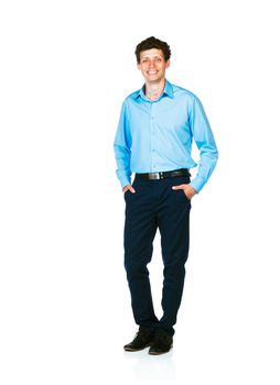 Happy young businessman standing with his hands in pockets on white background