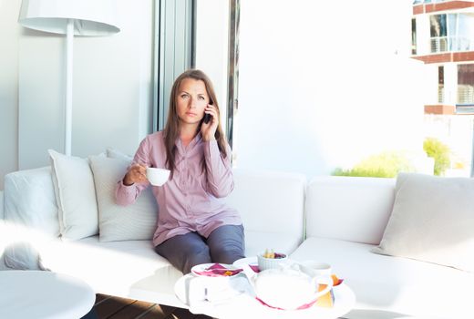 Businesswoman talking on the phone in a coffee shop