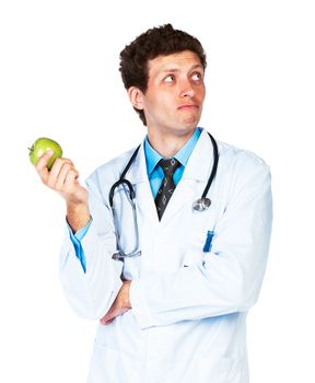 Portrait of a male doctor holding green apple on white background