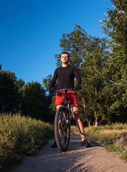 Mountain bike cyclist riding at sunrise healthy lifestyle active athlete doing sport