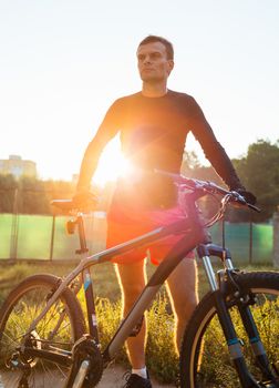 Mountain bike cyclist riding at sunrise healthy lifestyle active athlete doing sport