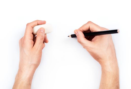 Human hands with pencil and erase rubber writting something. On white background