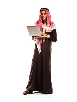 Young smiling arab with laptop isolated on white background