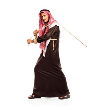 Young Arab pulling a rope isolated on white background