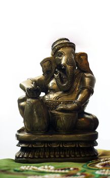 A metal statue of ganesha with musical instruments