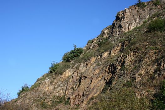 A landscape in the highlands, with rocks, trees and blue sky