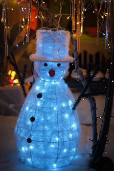 LALOR PARK, AUSTRALIA - DECEMBER 23, 2014;  Snowman with tophat on snow scene toy figure and christmas decorations and lights display