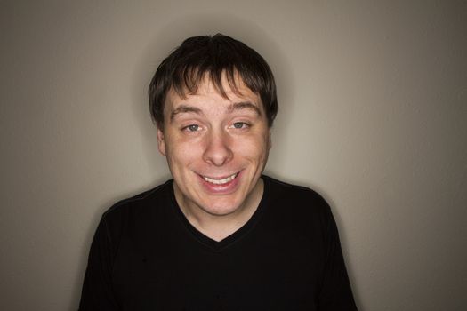 Guy looking at the camera with his eyes half open like he is stoned