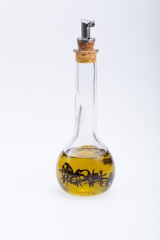 Thyme infused olive oil over white background 