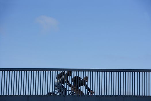 Bicycle Commuters on a Railing of bridge