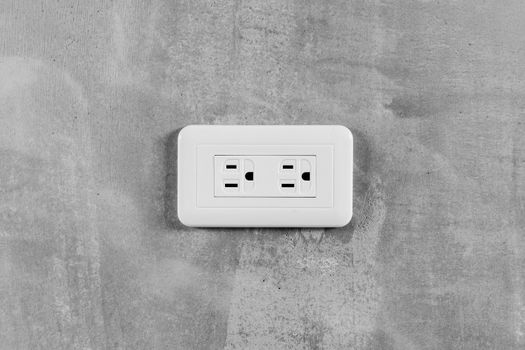 Socket, electrical outlet on gray wall. Close-up image.