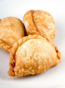 delicious fried Curry Puffs on white dish