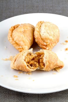 delicious fried Curry Puffs on white dish