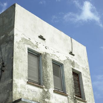 Disheveled small concrete building exterior