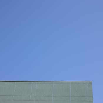 Grey rooftop against a perfect blue sky