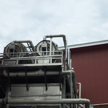 Large industrial equipment near a red building